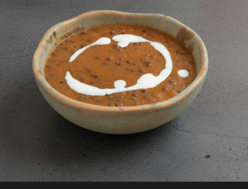 Dal makhani in a ceramic bowl, swirled with cream