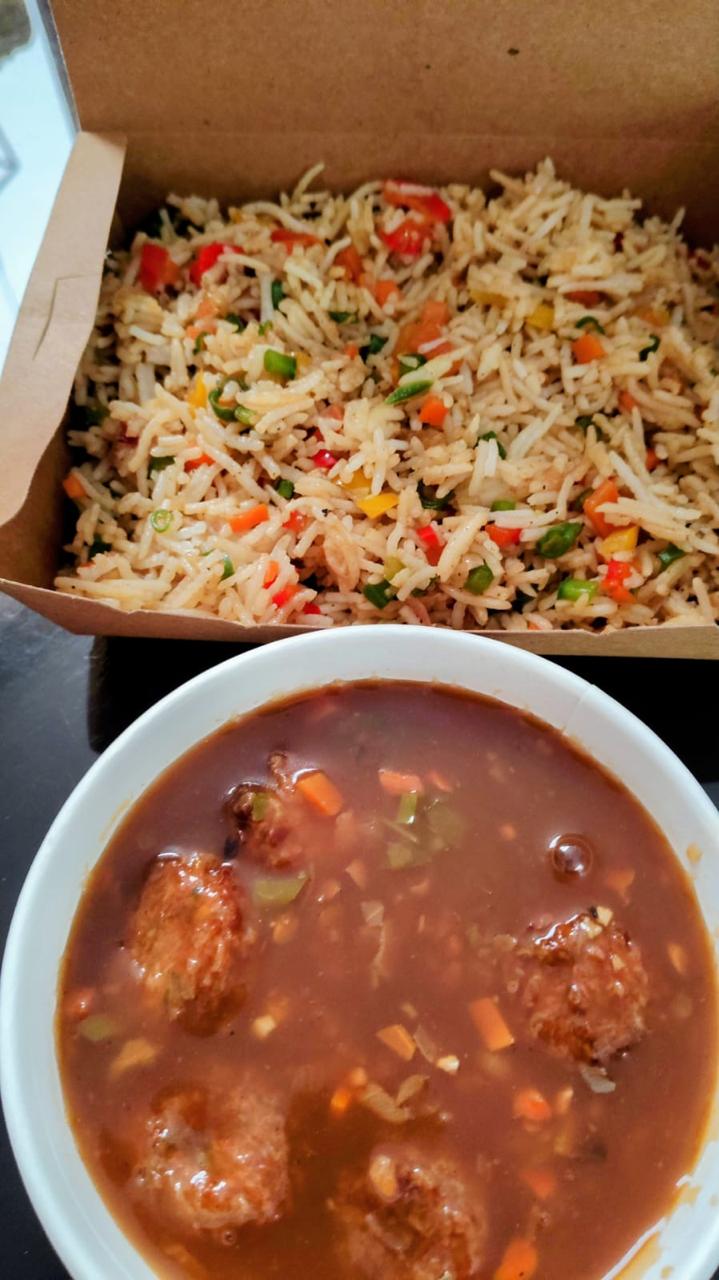 Veg fried rice in a kraft box with a bowl of veg manchurian